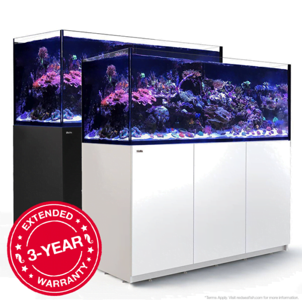 Two large reef aquariums on white and black stands with an extended 3-year warranty badge.