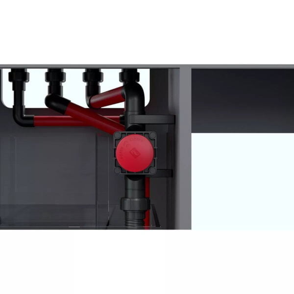 Close-up of an aquarium plumbing system with red and black pipes, featuring an open/close valve.